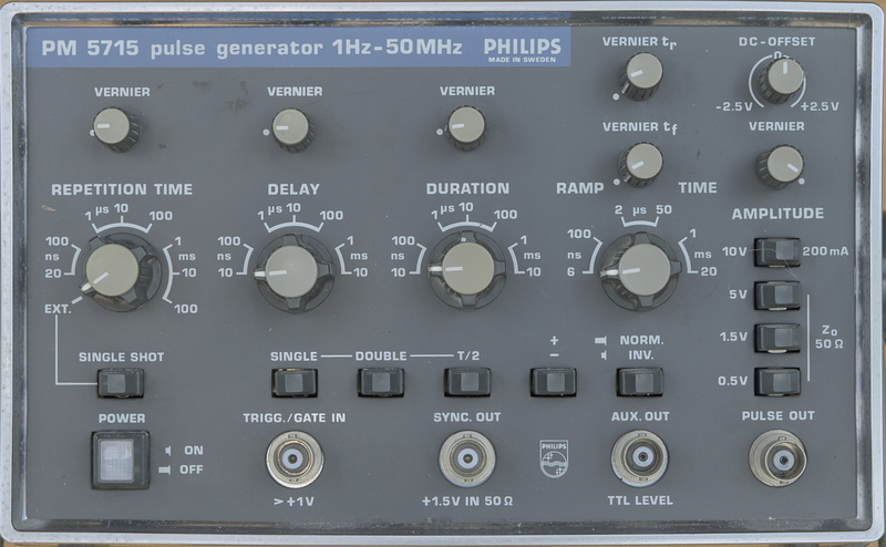 Image of the Philips PM5715 pulse generator front panel. Using very characteristics buttons and knobs for Philips around the 80s era. The color scheme using a particular brown with light gray accents. The logo and branding have a blue backdrop. The pulse generator lists prominently that it works from 1 to 50 MHz on the front panel.