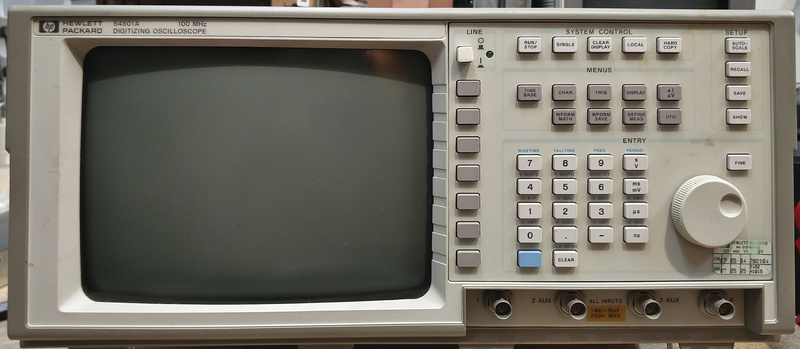 Image of the front panel of a HP 54501A digital oscilloscope. This oscilloscope uses a dial pad and limited buttons for its interface relying on the user interface shown on the CRT screen to drive the controls.