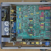 Philips PM5715 pulse generator PCB shows a mix of discrete transistors and custom Philips IC's. This PCB uses an older silk screen and masking technology that is known to bubble and foil of the PCB. However, this PCB is still in good condition and the PCB is relatively clean. The PCB is well embedded in the frame of the device and attached using several screws.