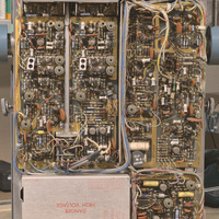 Bottom side view of the Tektronix type 453 analog oscilloscope with the top and bottom cover removed showing very tightly packed internal circuitry. The oscilloscope is standup upright.