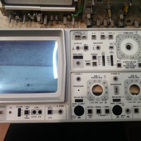Image showing a dirty front panel of the Hameg HM1005 analog oscilloscope. This front panel is detached from the rest of the instrument laying flat on a table. It is being prepared to be cleaned.