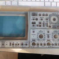 Image showing the now clean front panel of the Hameg HM1005 analog oscilloscope. This front panel is detached from the rest of the instrument laying flat on a table.