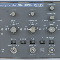 Image of the Philips PM5715 pulse generator front panel. Using very characteristics buttons and knobs for Philips around the 80s era. The color scheme using a particular brown with light gray accents. The logo and branding have a blue backdrop. The pulse generator lists prominently that it works from 1 to 50 MHz on the front panel.