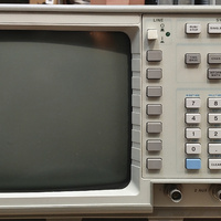 Image of the front panel of a HP 54501A digital oscilloscope. This oscilloscope uses a dial pad and limited buttons for its interface relying on the user interface shown on the CRT screen to drive the controls.
