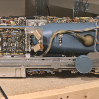 Left side view of the Tektronix type 453 analog oscilloscope with the top and bottom cover removed showing the CRT mylar casing and part of the CRT deflection drivers.